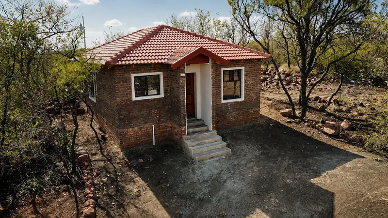 Rustic Retreat cabin exterior surrounded by bushveld